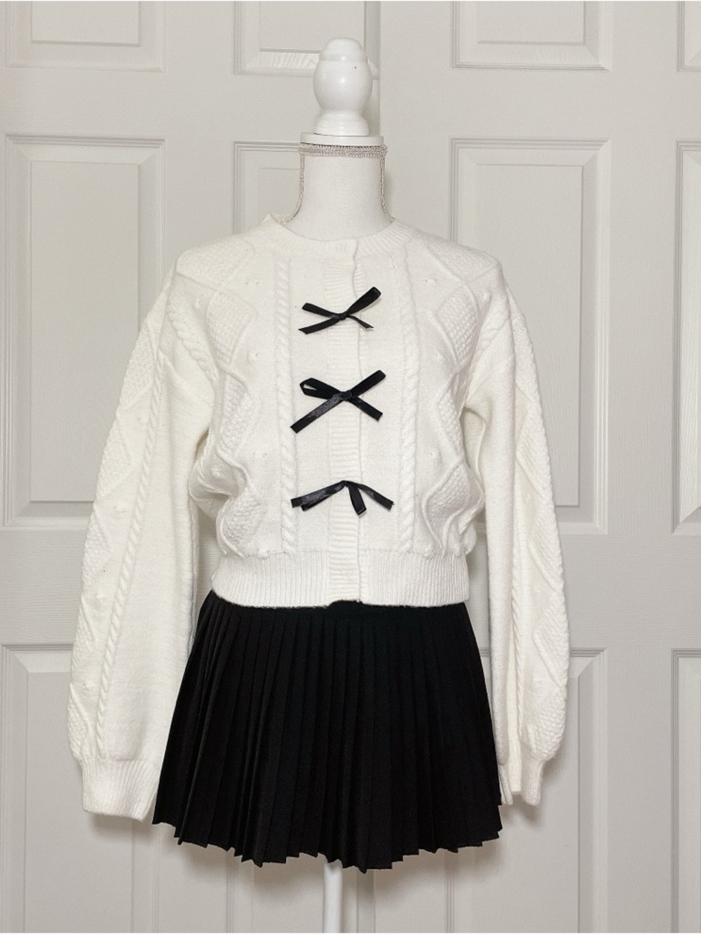 White sweater with black ribbons